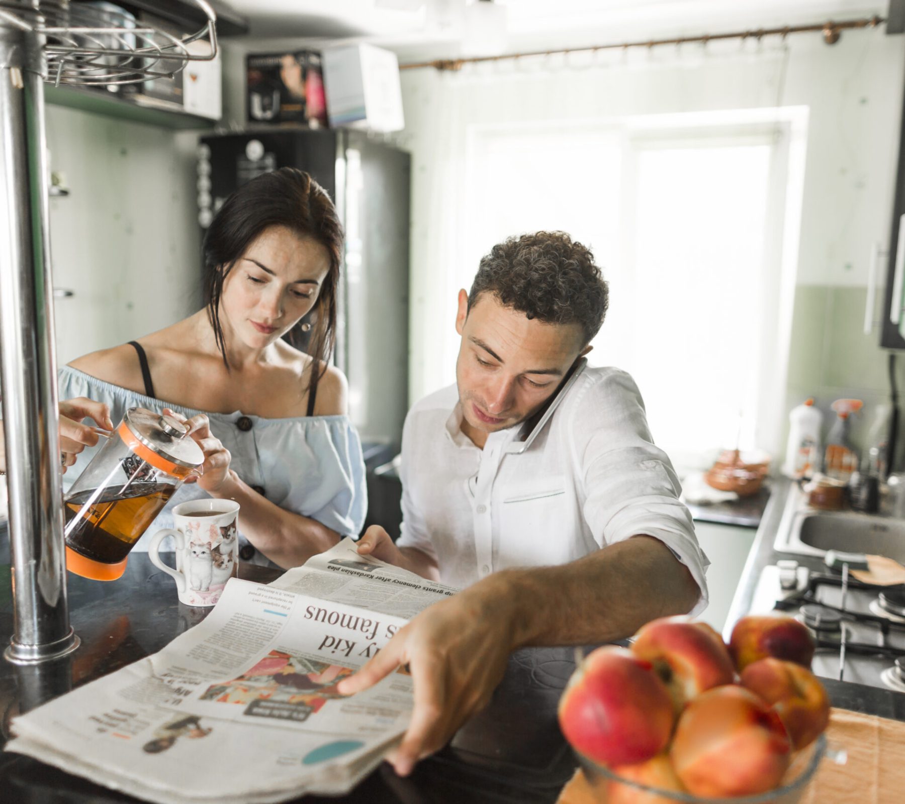 woman-pouring-coffee-mug-sitting-near-husband-talking-mobile-phone